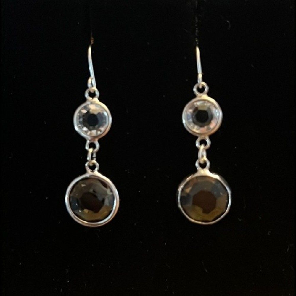 Handcrafted silver tone earrings with a Smokey and clear colored stone.